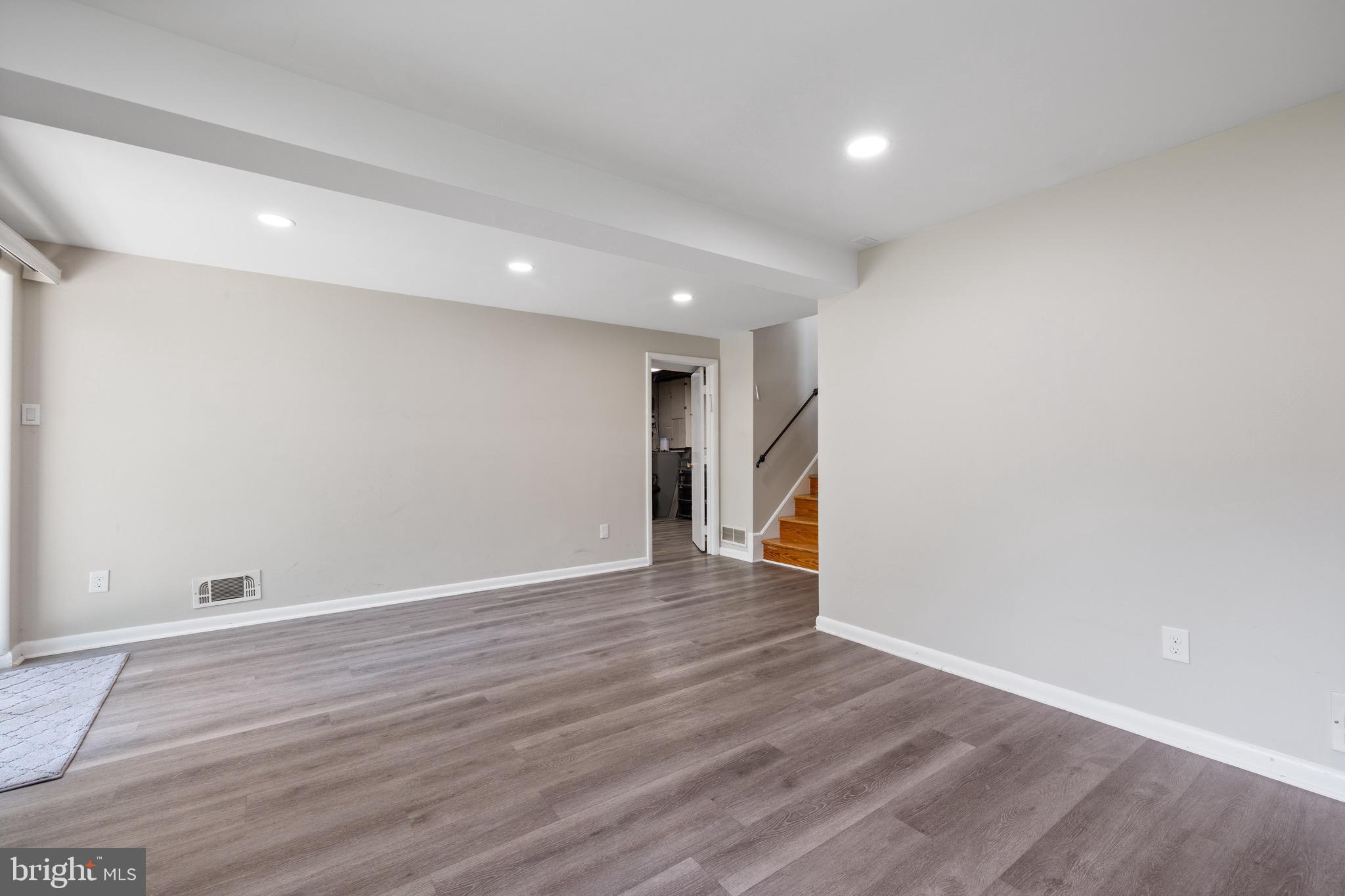 916 Hyde Road Silver Spring, MD 20902 - Photo 22 of 27 a view of an empty room with wooden floor