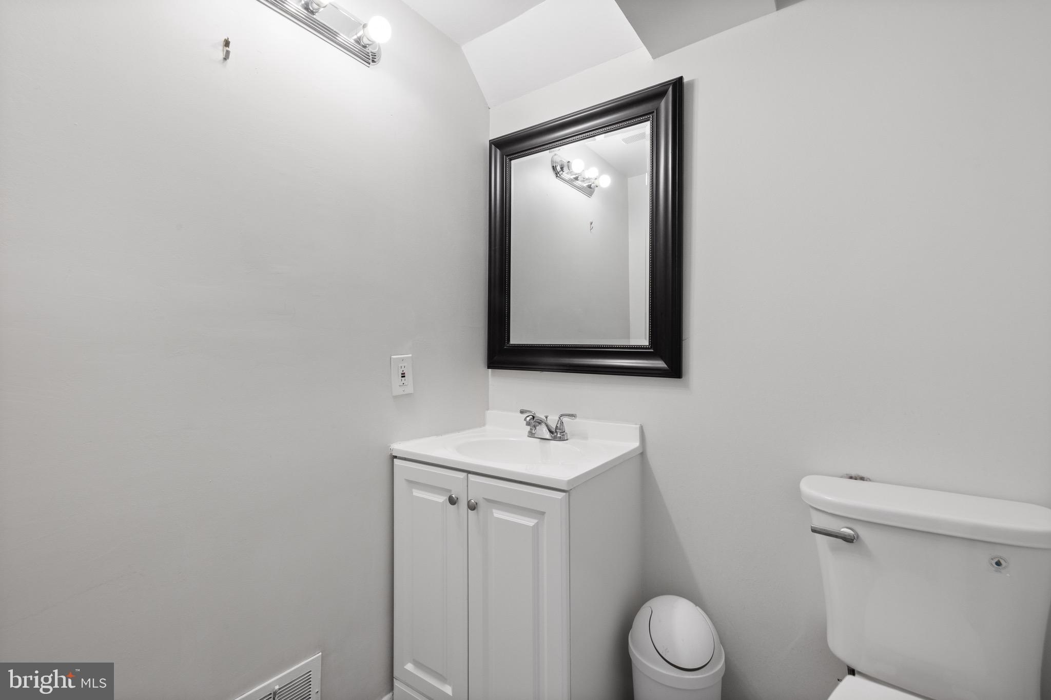 916 Hyde Road Silver Spring, MD 20902 - Photo 24 of 27 a bathroom with a toilet sink and mirror