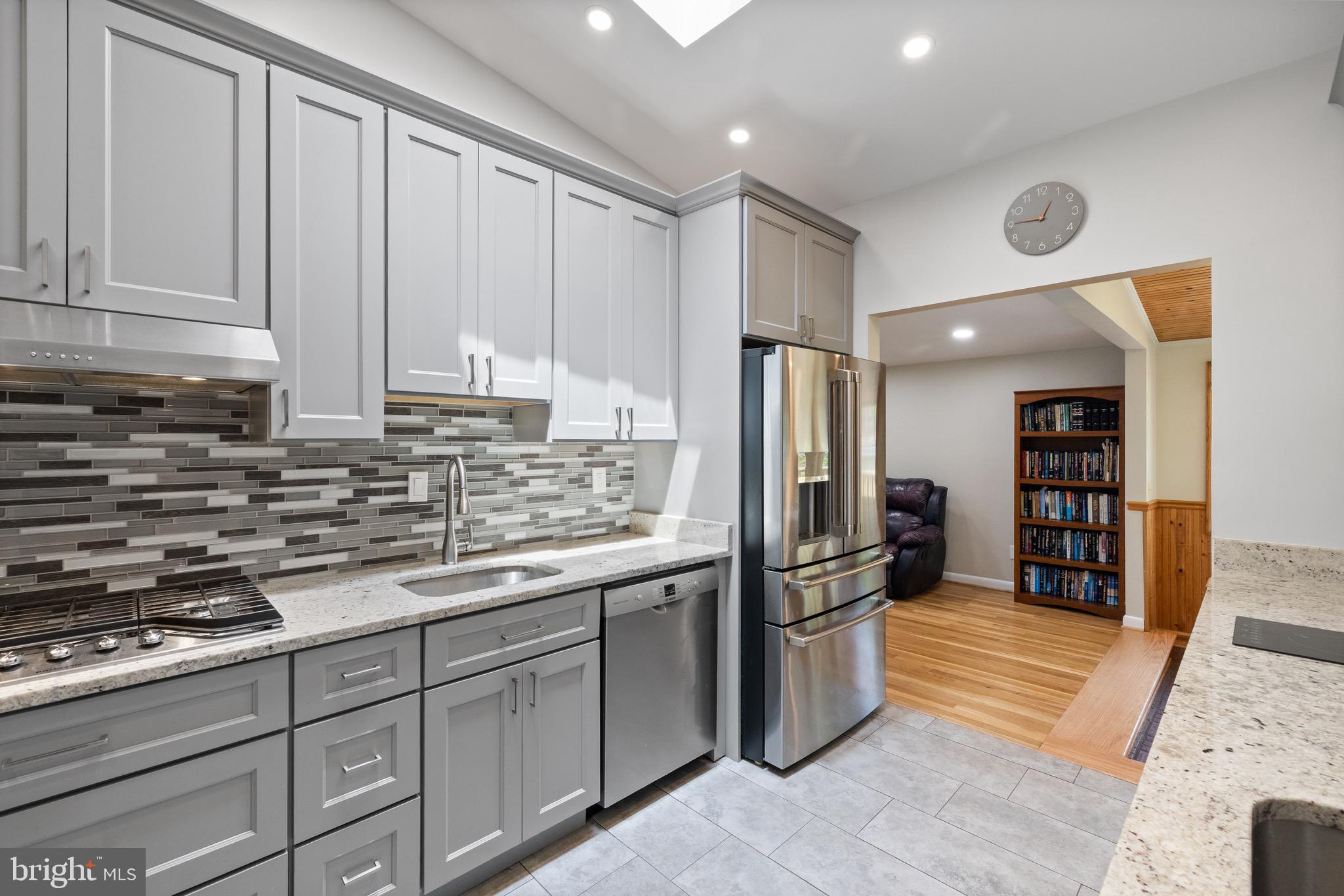 916 Hyde Road Silver Spring, MD 20902 - Photo 3 of 27 a kitchen with stainless steel appliances granite countertop a refrigerator and a stove top oven