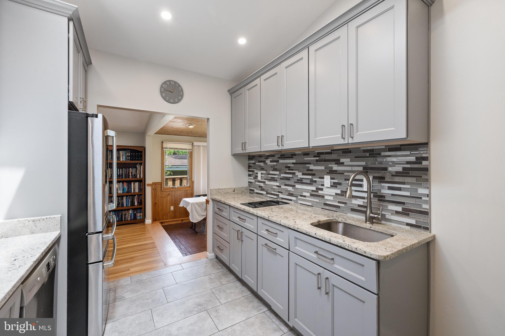 916 Hyde Road Silver Spring, MD 20902 - Photo 5 of 27 a kitchen with a sink stove and cabinets