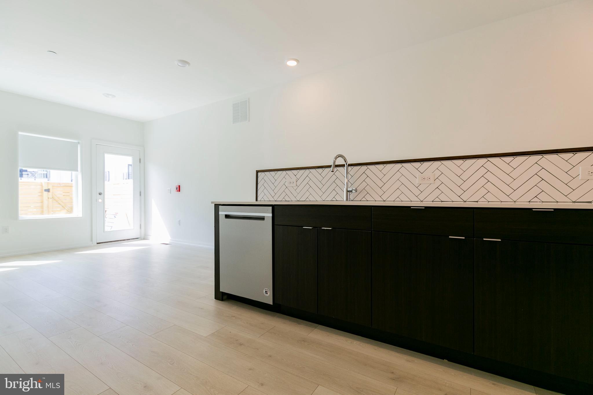 1240 LeCount Street, Unit A Philadelphia, PA 19121 - Photo 3 of 14 a living room with a black white checkered floor