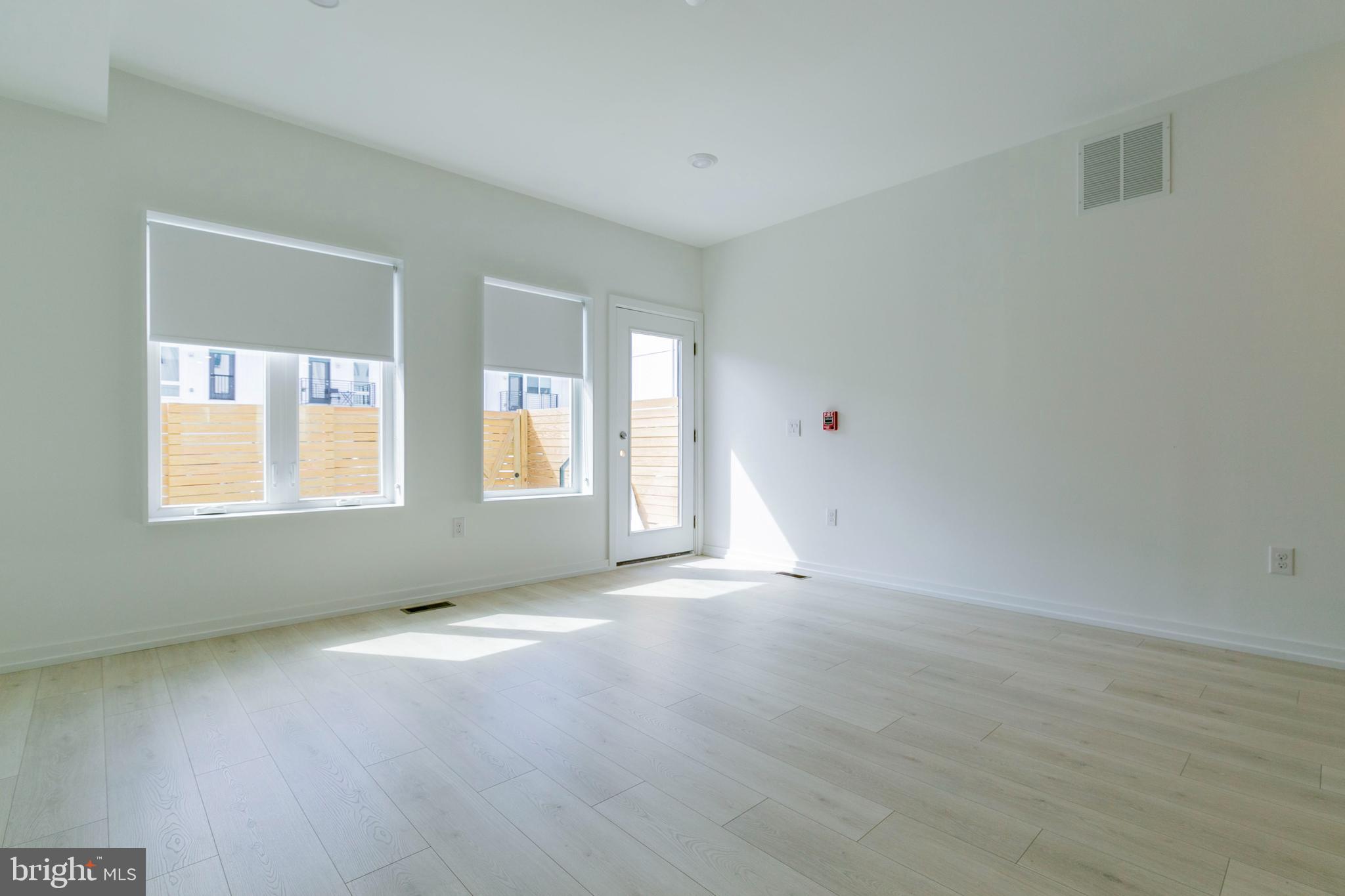 1240 LeCount Street, Unit A Philadelphia, PA 19121 - Photo 6 of 14 a view of an empty room with wooden floor and a window