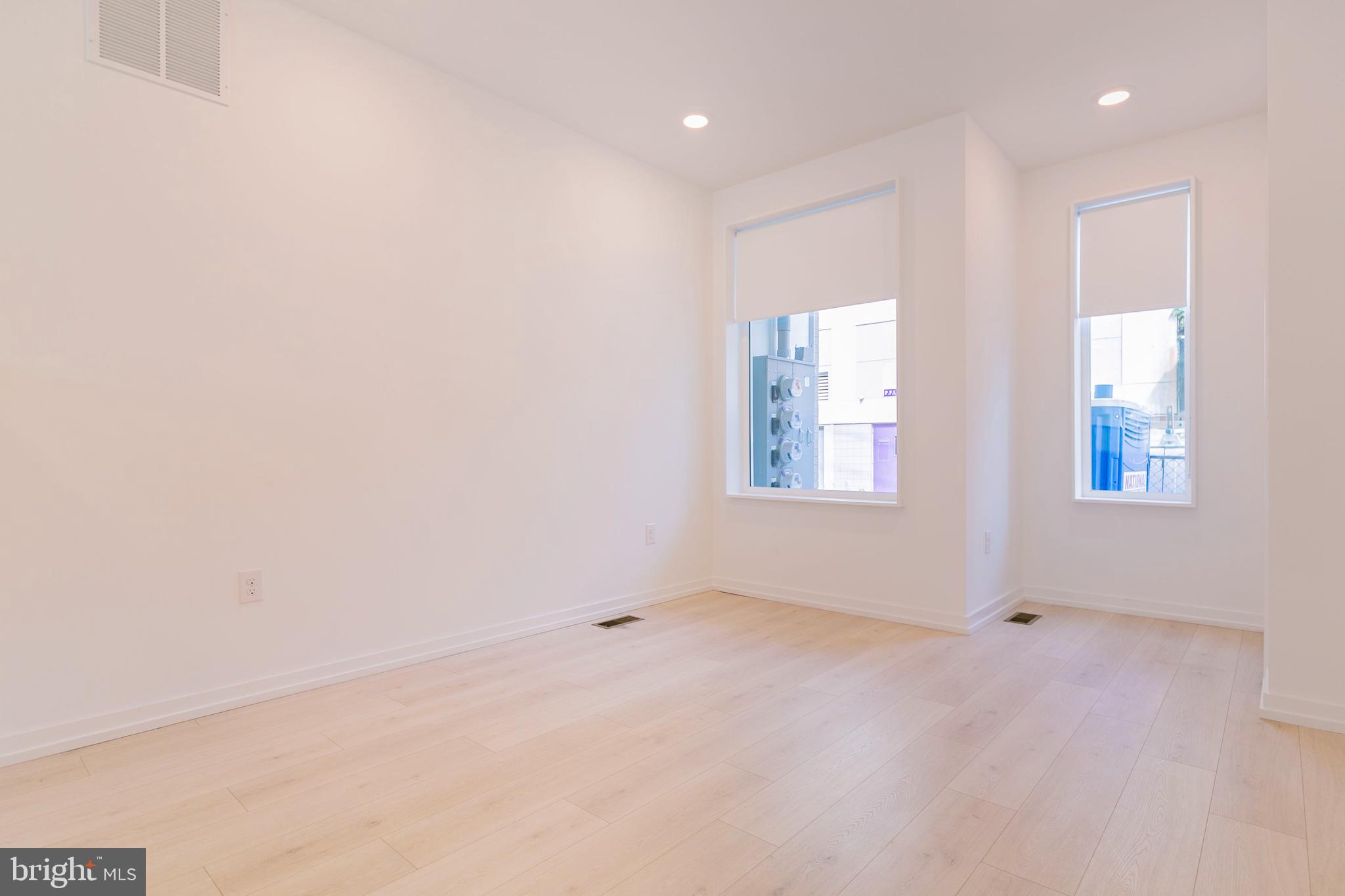 1240 LeCount Street, Unit A Philadelphia, PA 19121 - Photo 7 of 14 an empty room with windows