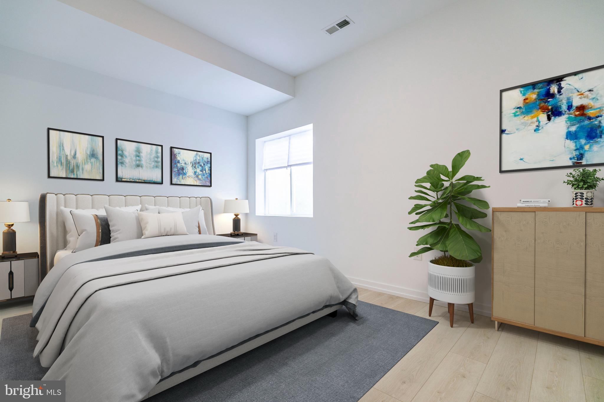 1240 LeCount Street, Unit A Philadelphia, PA 19121 - Photo 8 of 14 a bedroom with a bed and a painting on the wall