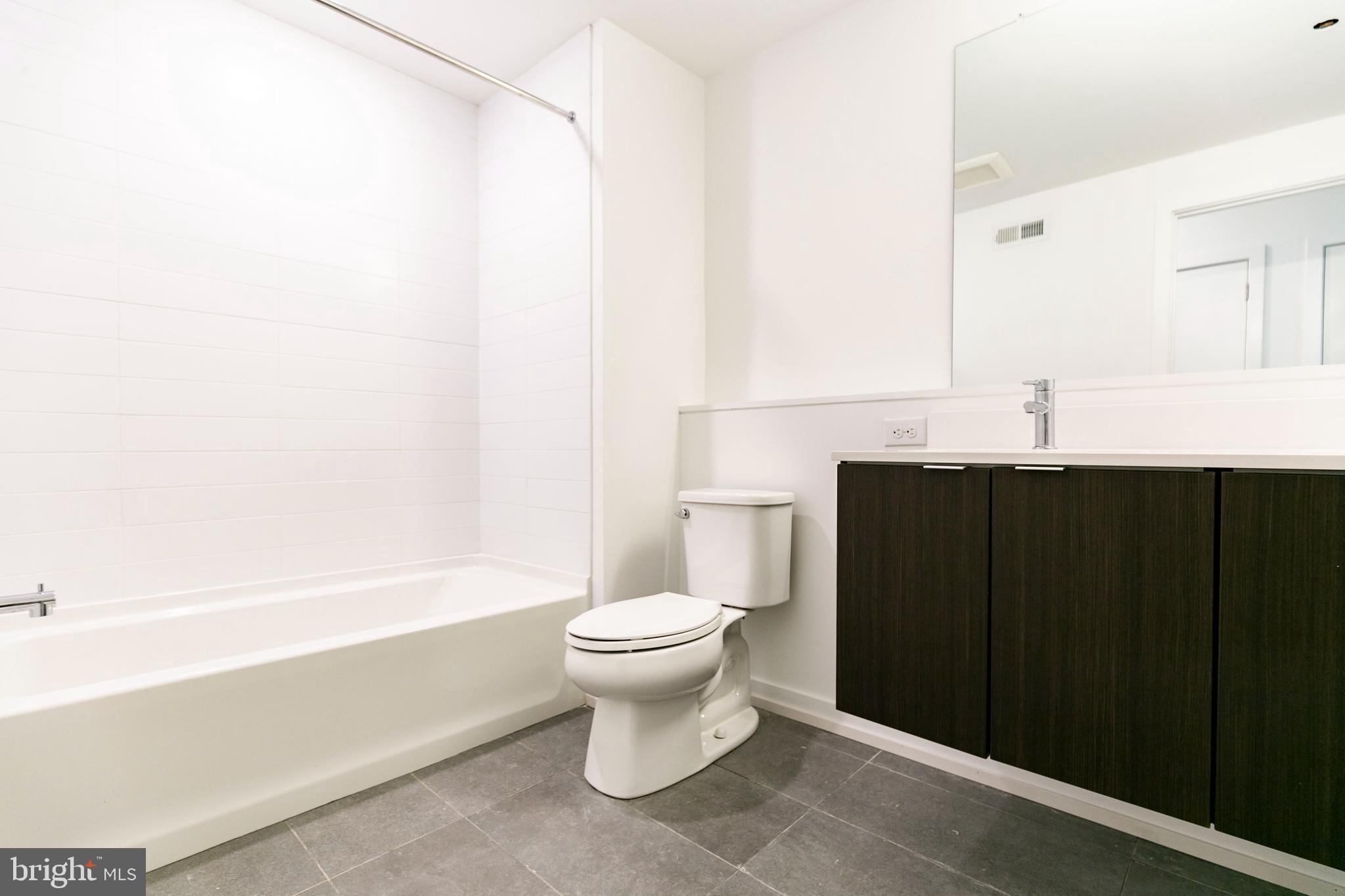 1240 LeCount Street, Unit A Philadelphia, PA 19121 - Photo 9 of 14 a bathroom with a sink a toilet and shower