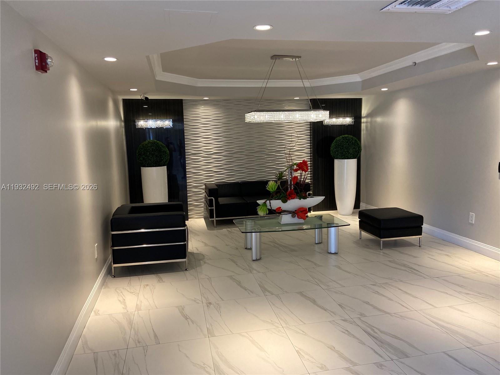 17050 North Bay Road, Unit 1102 Sunny Isles Beach, FL 33160 - Photo 3 of 10 a living room with furniture and a wooden floor