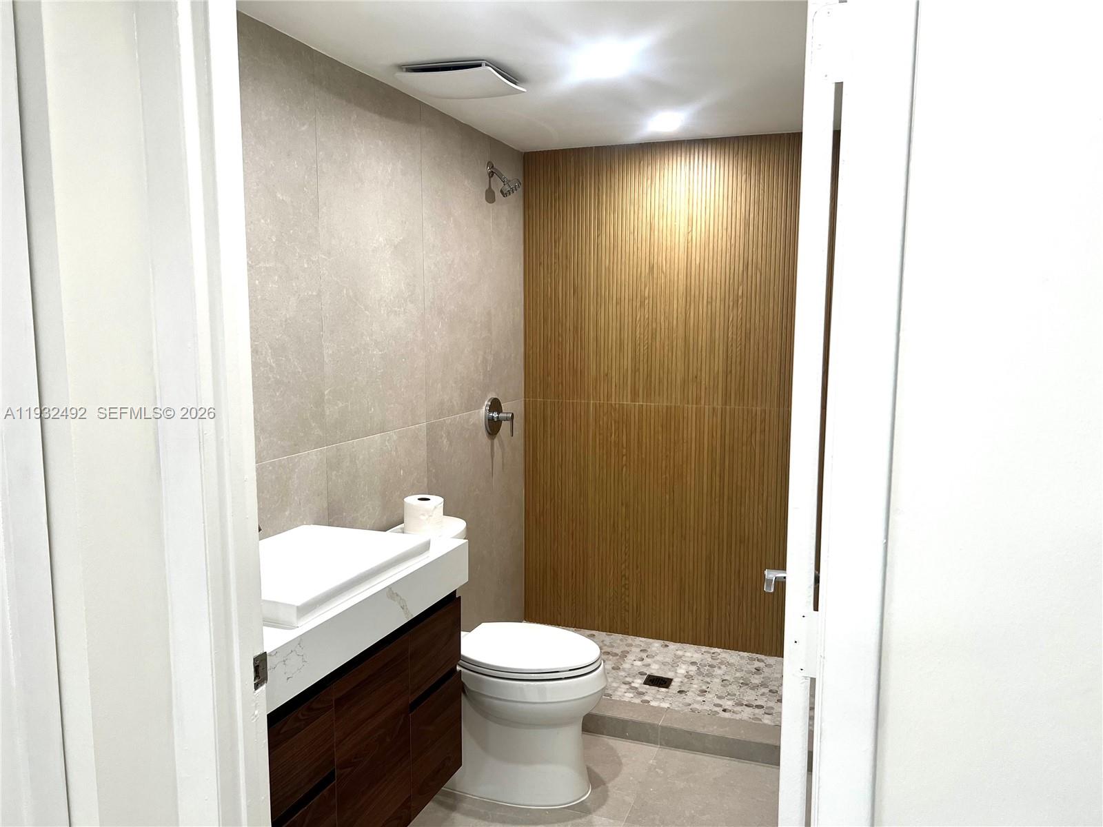 17050 North Bay Road, Unit 1102 Sunny Isles Beach, FL 33160 - Photo 6 of 10 a bathroom with a sink a toilet and shower