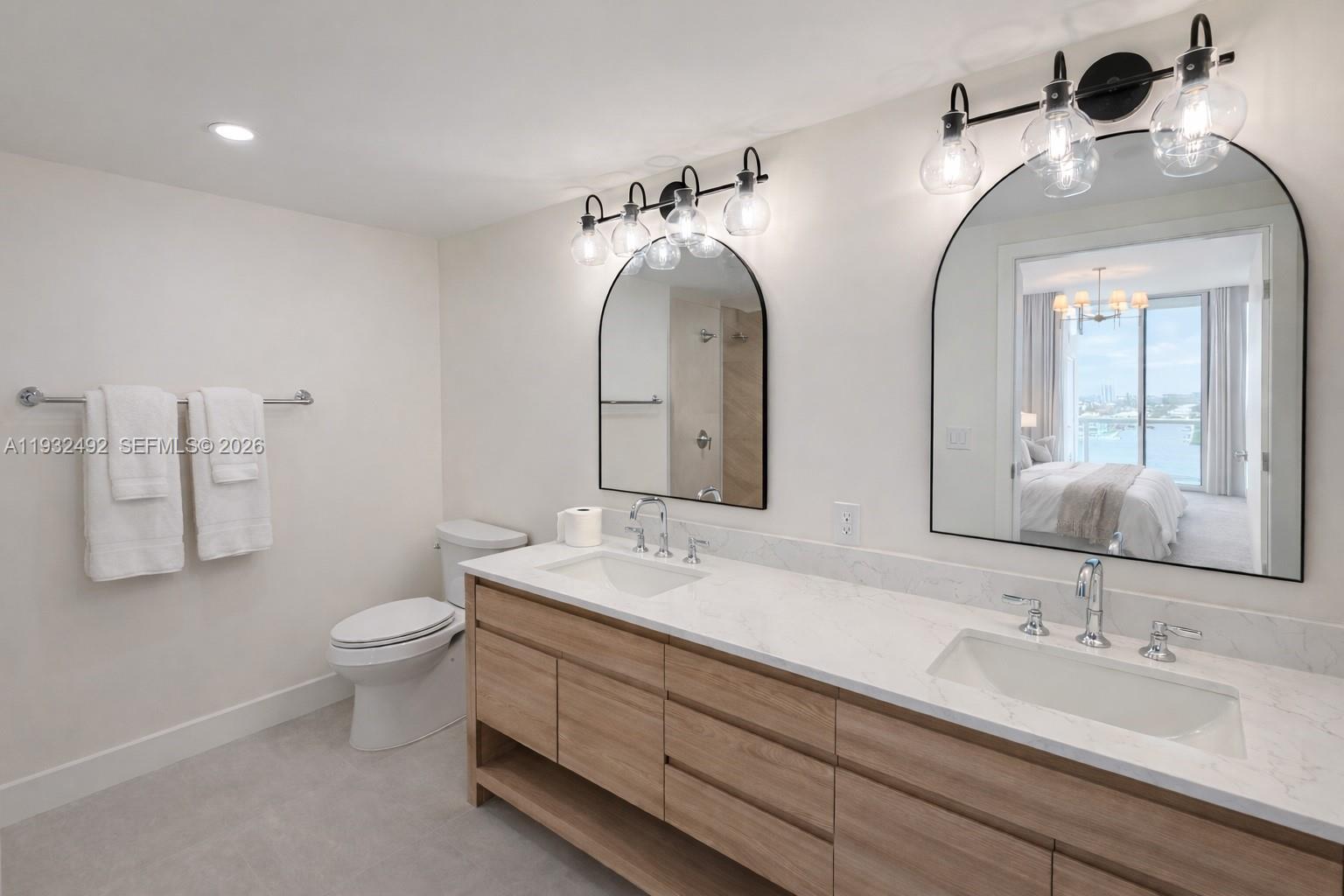 17050 North Bay Road, Unit 1102 Sunny Isles Beach, FL 33160 - Photo 7 of 10 a bathroom with 2 sink and a mirror