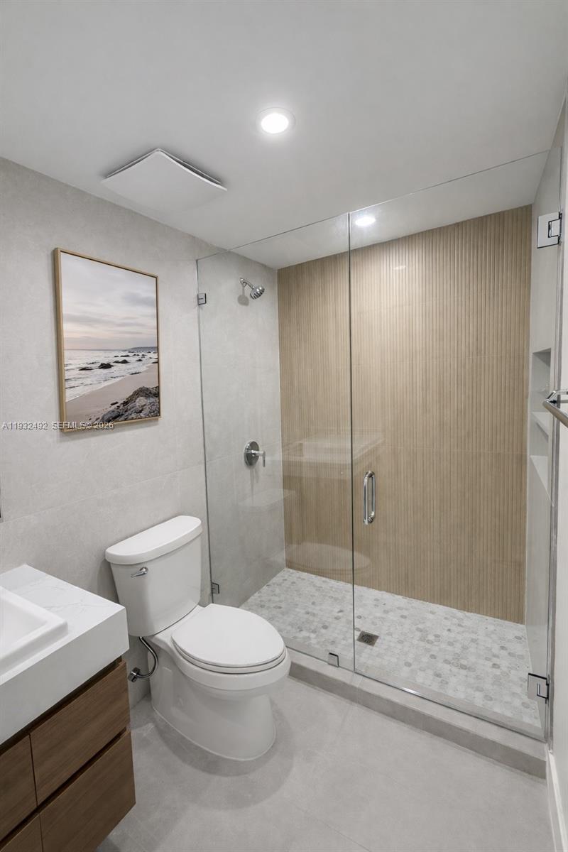 17050 North Bay Road, Unit 1102 Sunny Isles Beach, FL 33160 - Photo 8 of 10 a bathroom with a toilet a sink and shower