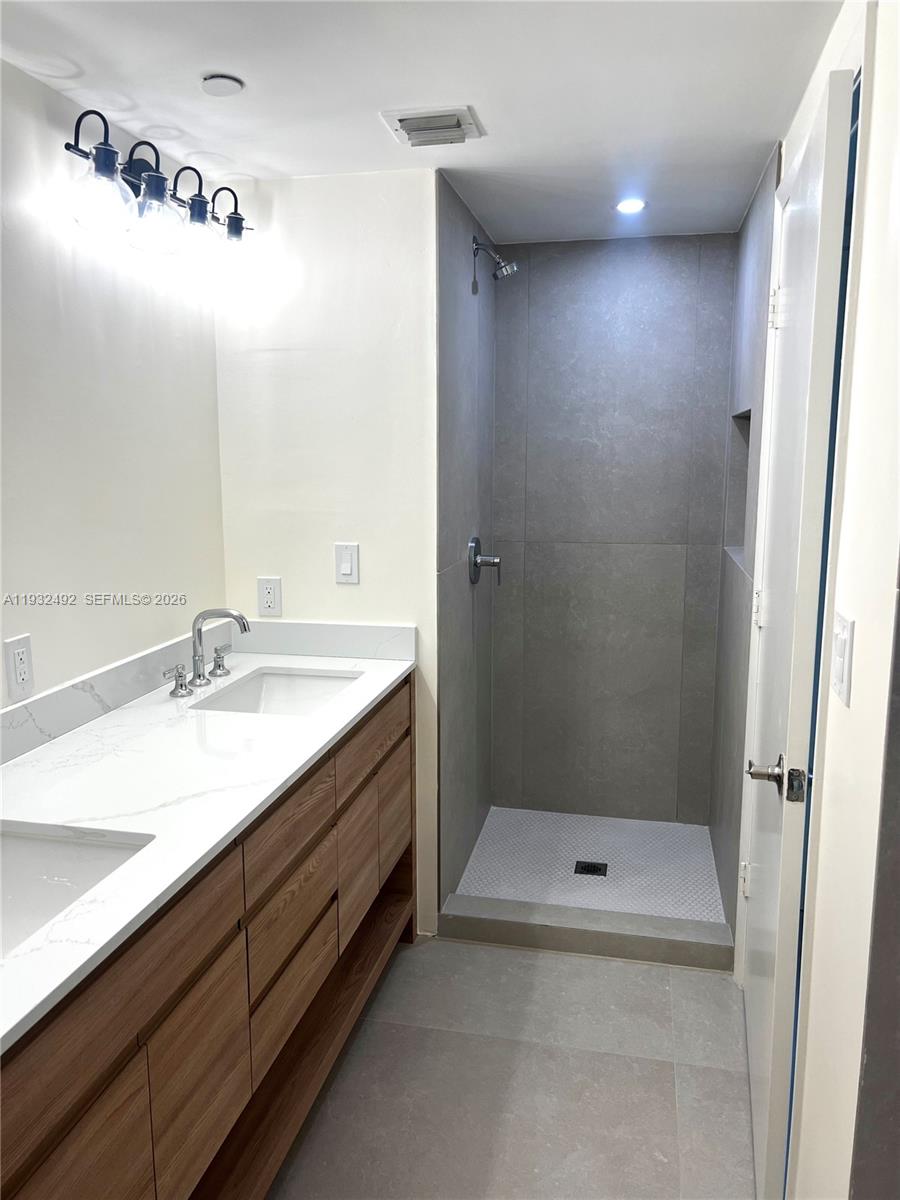 17050 North Bay Road, Unit 1102 Sunny Isles Beach, FL 33160 - Photo 8 of 10 a bathroom with a granite countertop sink a toilet and shower