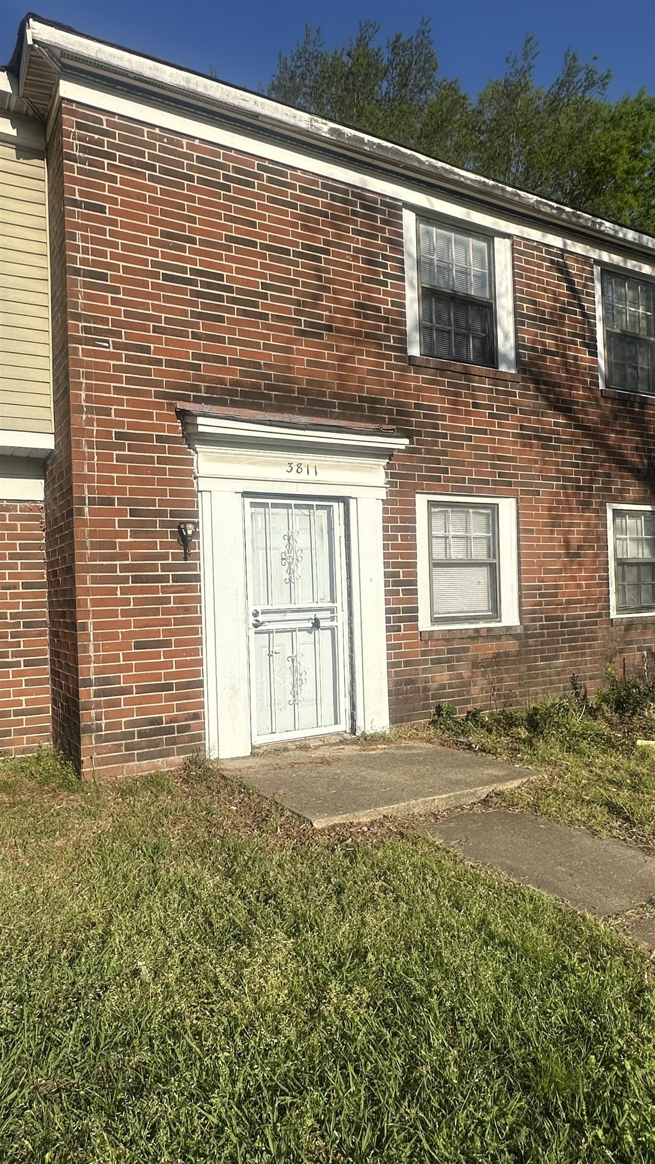3811 South Mendenhall Road, Unit 3811 Memphis, TN 38115 - Photo 1 of 18 Entrance to property with a lawn and brick siding