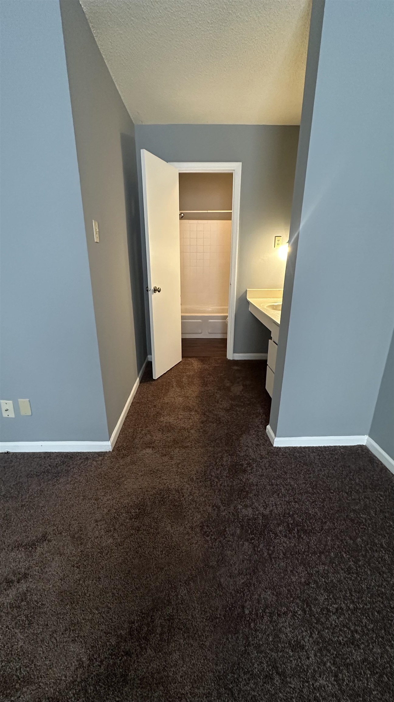 3811 South Mendenhall Road, Unit 3811 Memphis, TN 38115 - Photo 4 of 18 Corridor featuring baseboards, dark carpet, and a textured ceiling