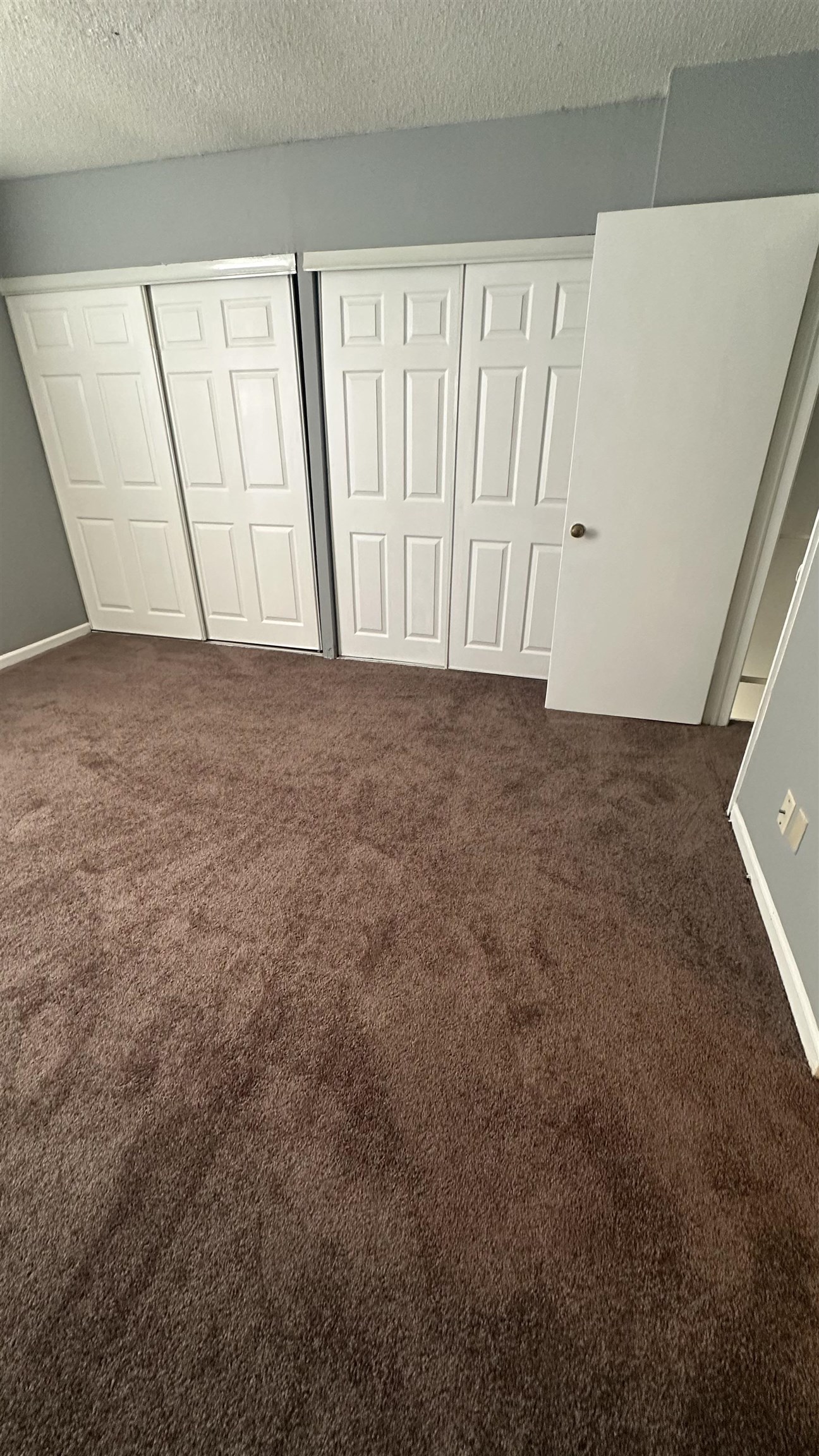 3811 South Mendenhall Road, Unit 3811 Memphis, TN 38115 - Photo 5 of 18 Unfurnished bedroom with a textured ceiling and carpet floors