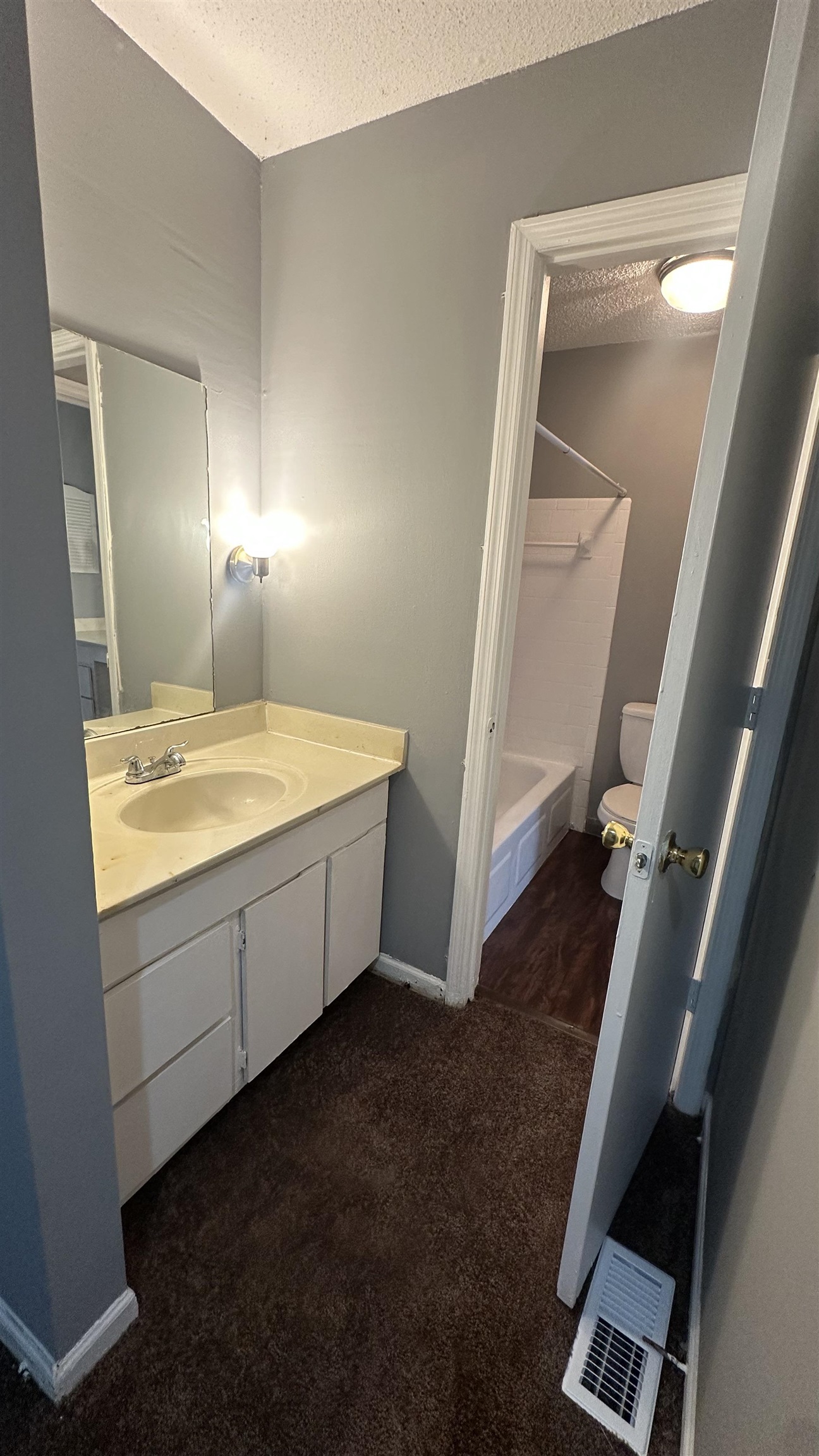 3811 South Mendenhall Road, Unit 3811 Memphis, TN 38115 - Photo 8 of 18 Bathroom featuring a textured ceiling, visible vents, toilet, shower / washtub combination, and vanity