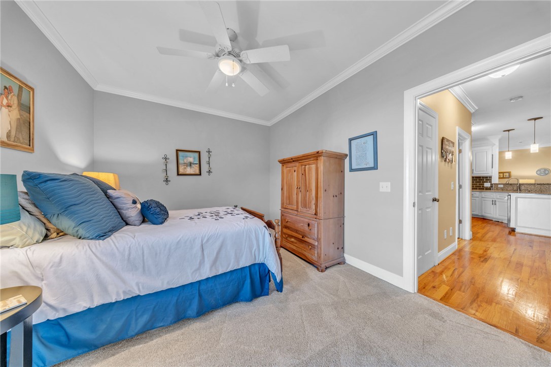 648 Mountain View Road Williamston, SC 29697 - Photo 26 of 42 Comfortable bedroom with soft carpeting transitions seamlessly to a vibrant kitchen with hardwood flooring.