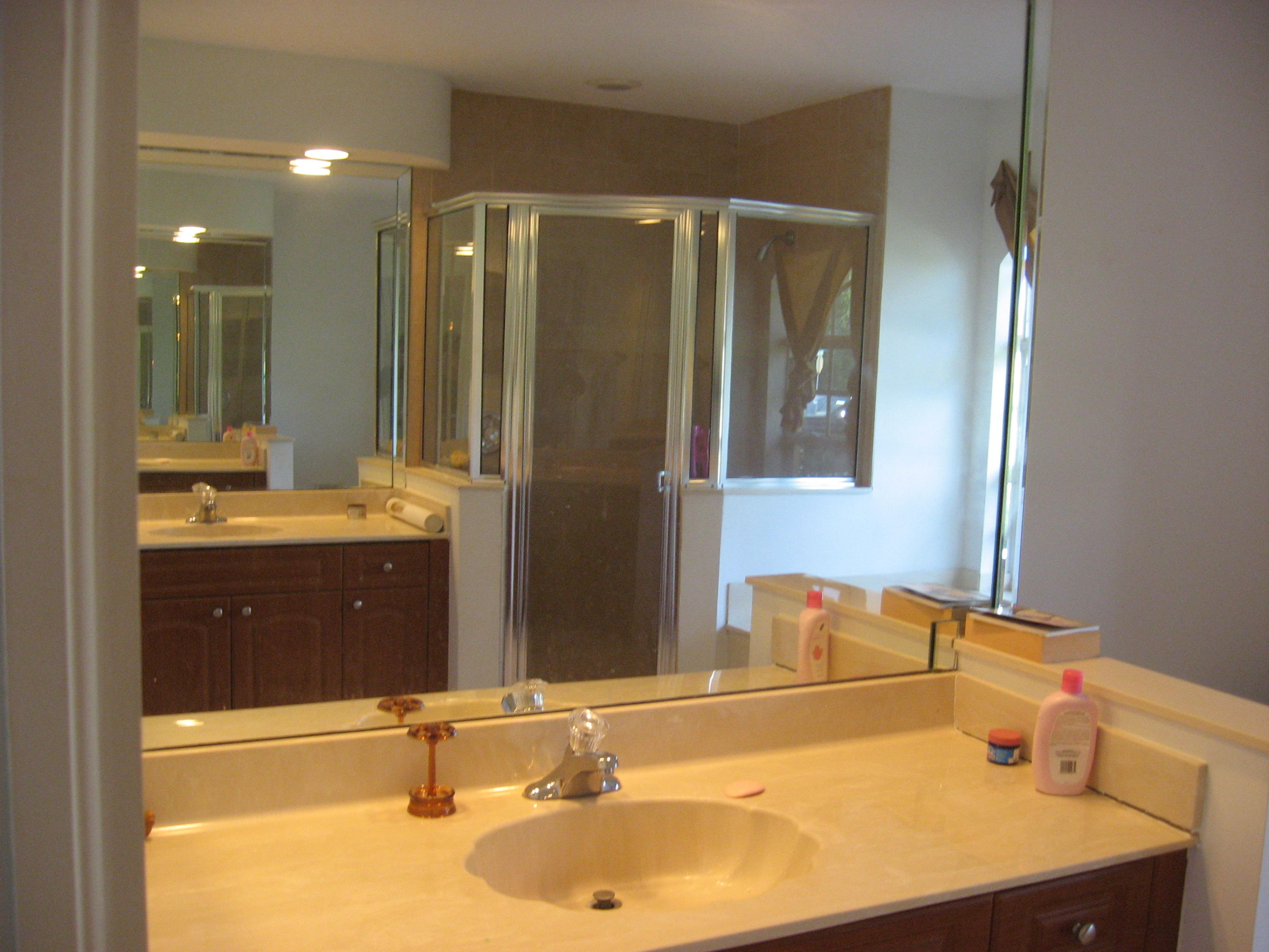 504 Southwest Undallo Road Port St. Lucie, FL 34953 - Photo 11 of 23 a bathroom with a sink and a mirror