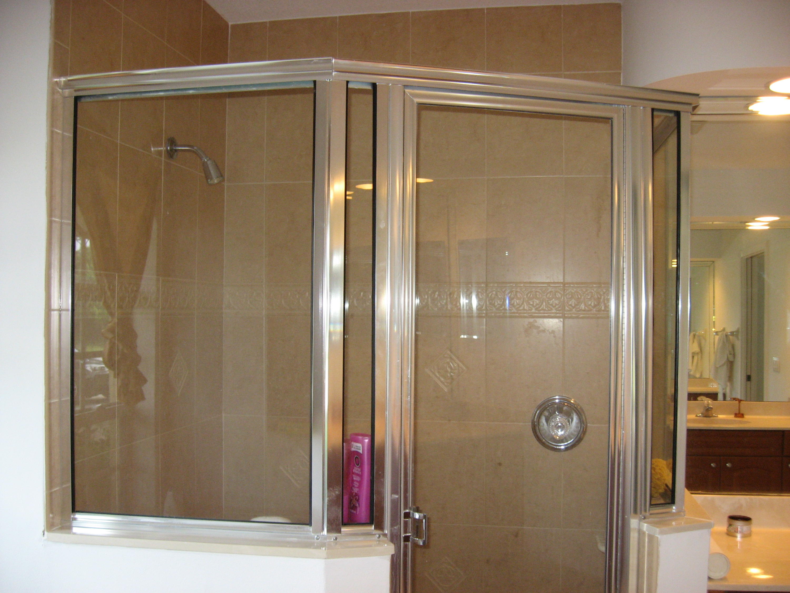 504 Southwest Undallo Road Port St. Lucie, FL 34953 - Photo 13 of 23 a bathroom with a glass shower door and a sink