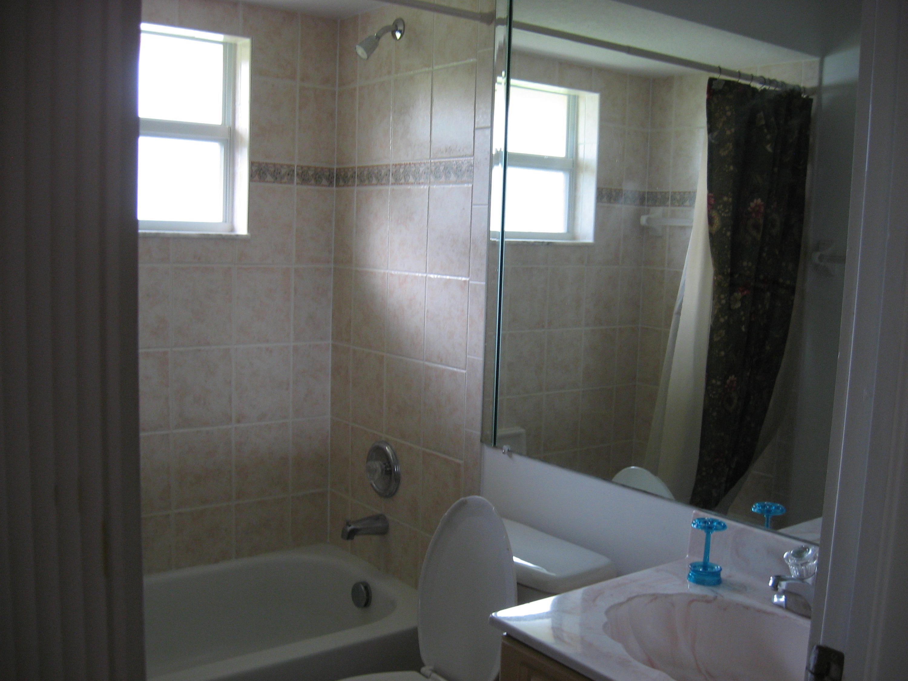 504 Southwest Undallo Road Port St. Lucie, FL 34953 - Photo 18 of 23 a bathroom with a toilet and a shower