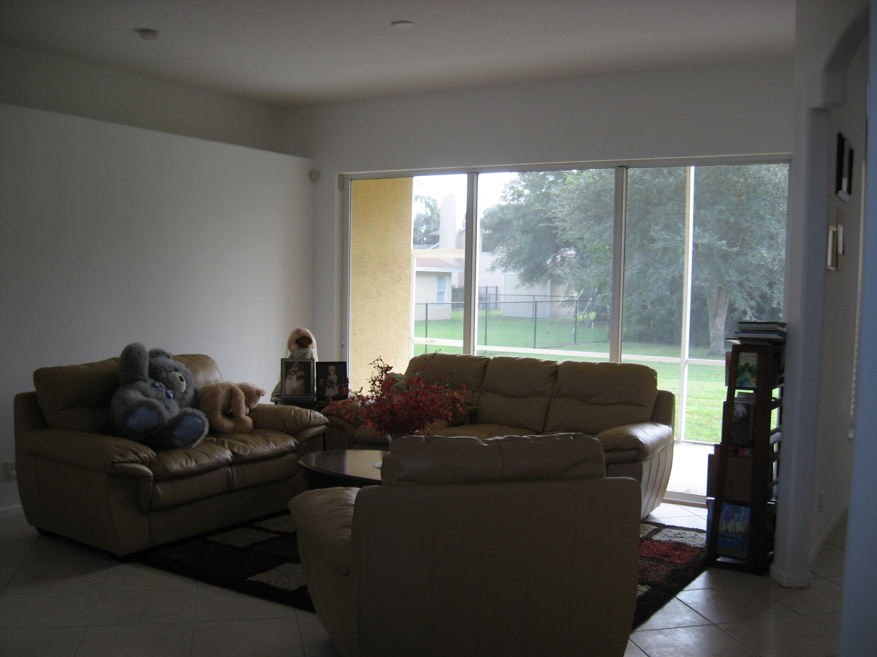 504 Southwest Undallo Road Port St. Lucie, FL 34953 - Photo 3 of 23 a living room with furniture and a large window