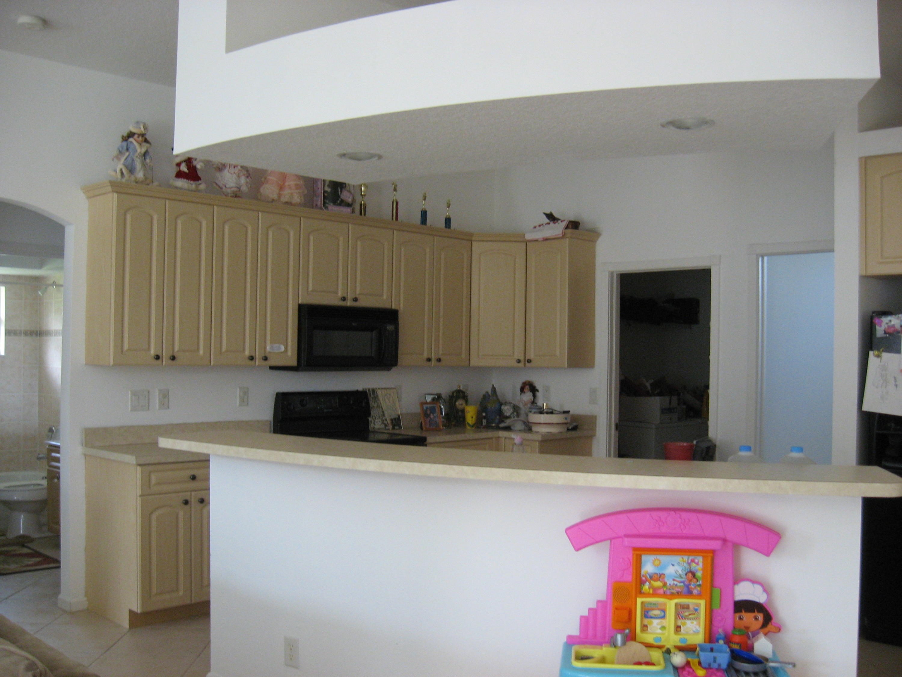 504 Southwest Undallo Road Port St. Lucie, FL 34953 - Photo 5 of 23 a kitchen with a sink stove and microwave