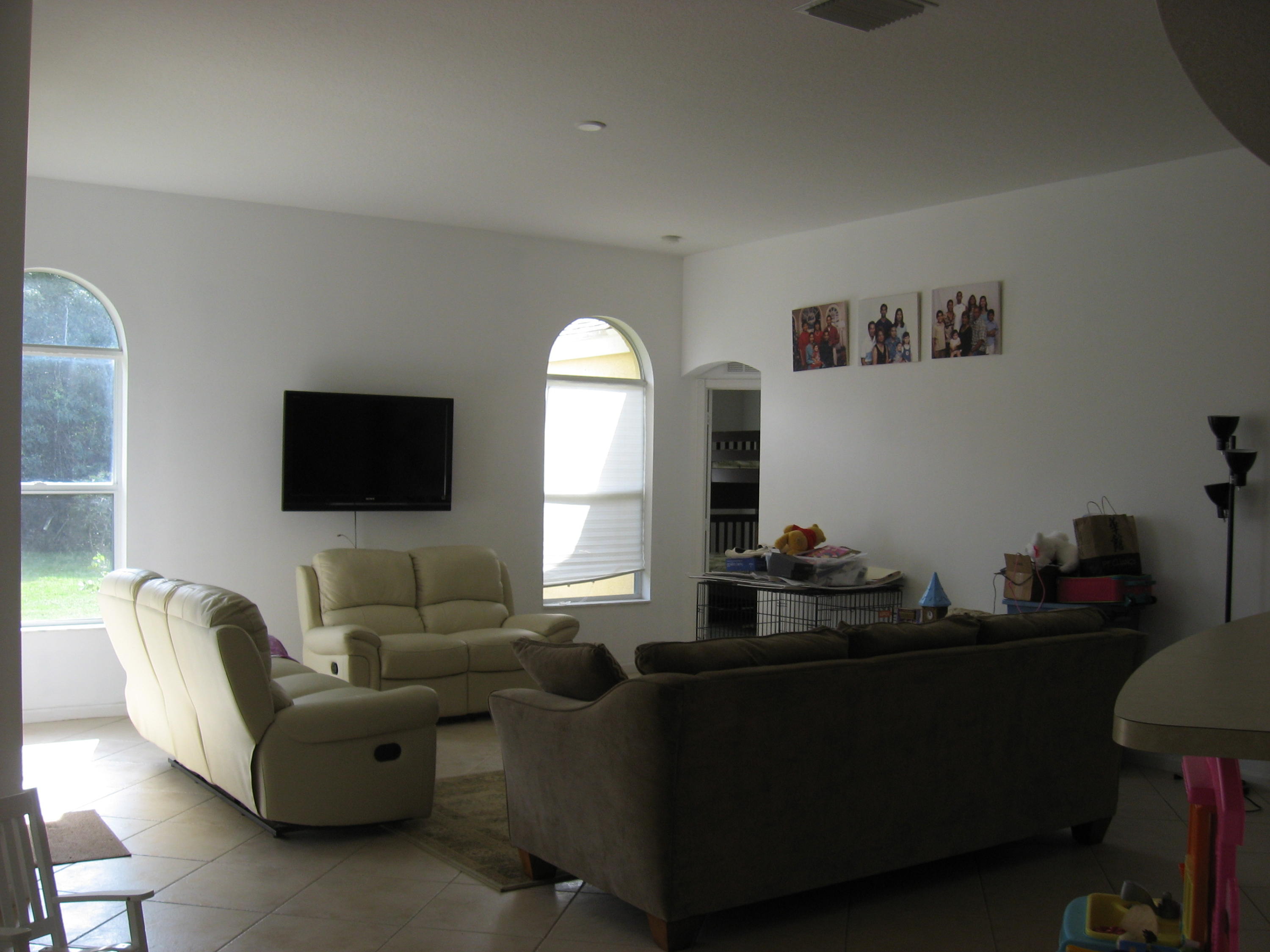 504 Southwest Undallo Road Port St. Lucie, FL 34953 - Photo 8 of 23 a living room with furniture and a flat screen tv