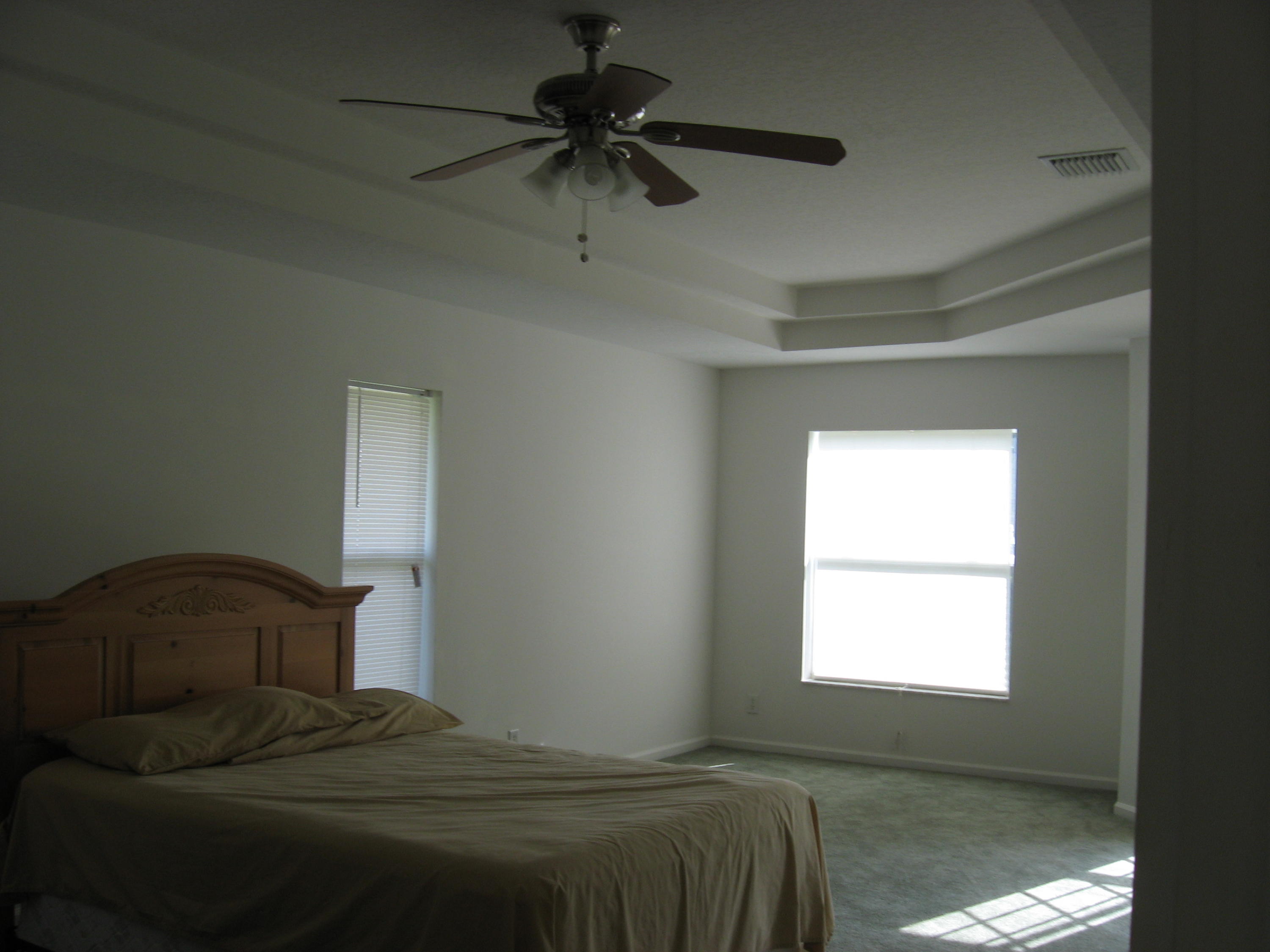 504 Southwest Undallo Road Port St. Lucie, FL 34953 - Photo 9 of 23 a bedroom with a bed and a window
