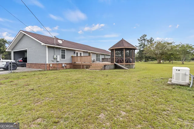 a backyard of a house with table and chairs