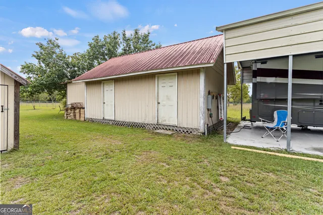 a view of a house with a backyard and a patio