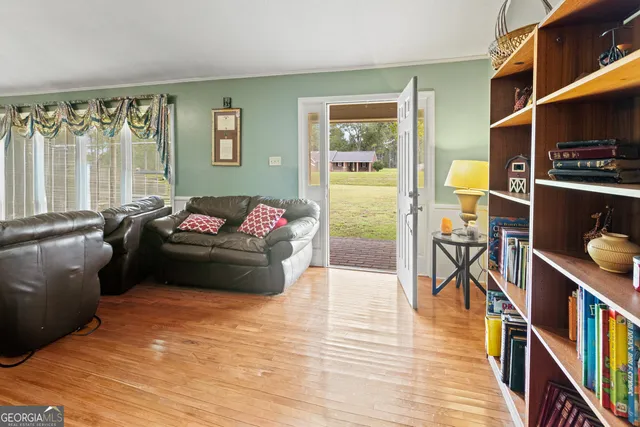 a living room with furniture fireplace and a large window