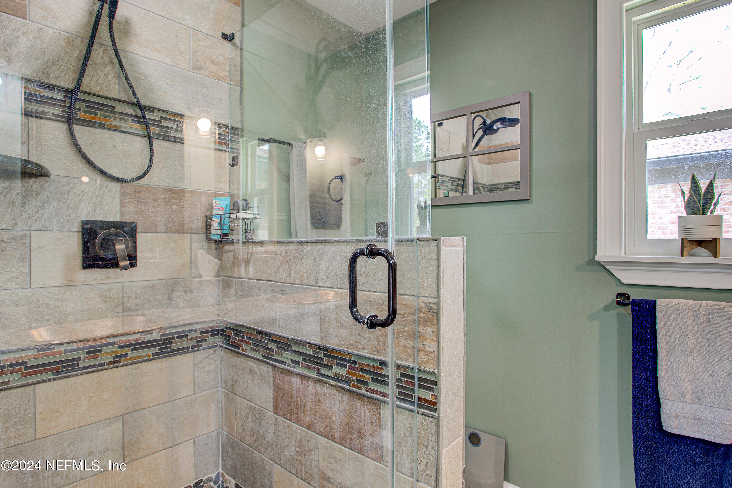 3963 Bronco Road Middleburg, FL 32068 - Photo 32 of 43 a bathroom with a granite countertop shower a mirror and a shower
