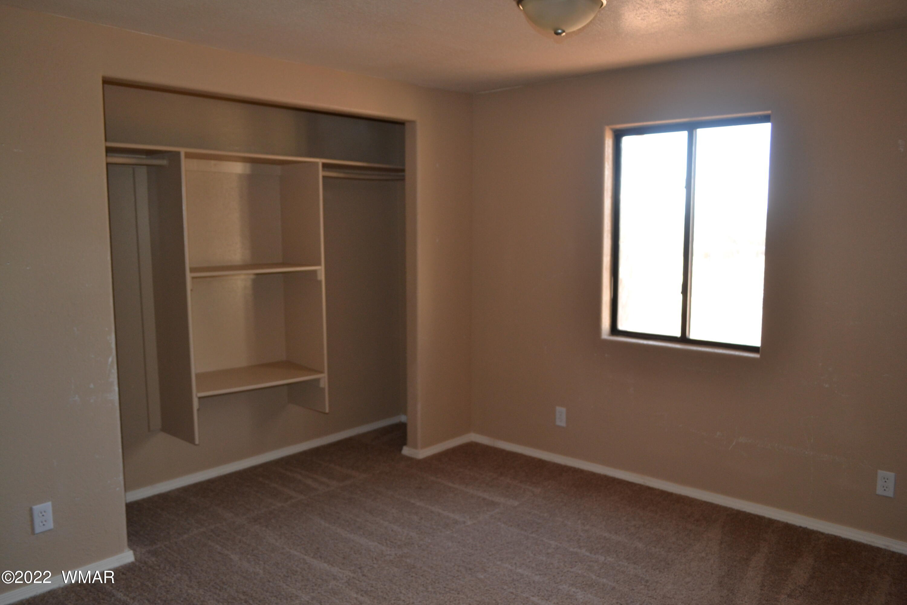 4330 Mountain View Road Snowflake, AZ 85937 - Photo 8 of 20 an empty room with windows and closet