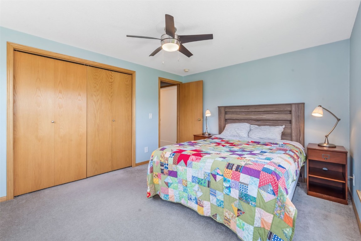 2981 Abbey Road Steamboat Springs, CO 80487 - Photo 25 of 27 a bedroom with a bed and a chandelier
