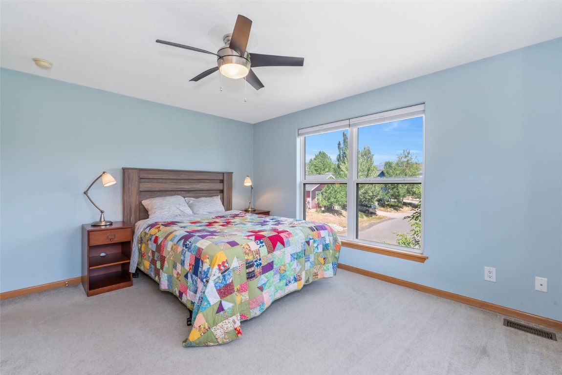 2981 Abbey Road Steamboat Springs, CO 80487 - Photo 26 of 27 a bedroom with a bed and a ceiling fan