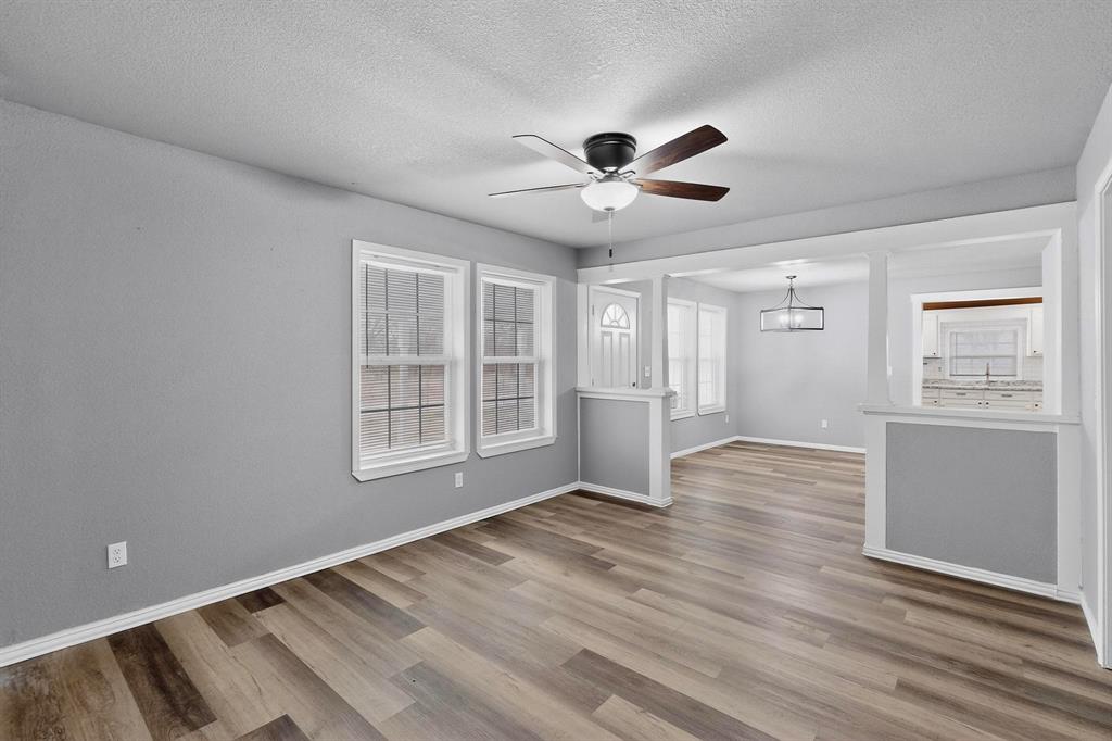 400 South Oak Street Ranger, TX 76470 - Photo 12 of 38 a view of an empty room with a window and wooden floor