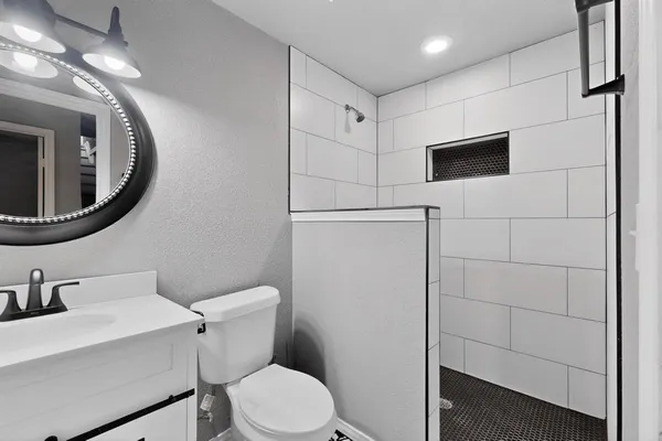 a white toilet sitting next to a bathroom sink