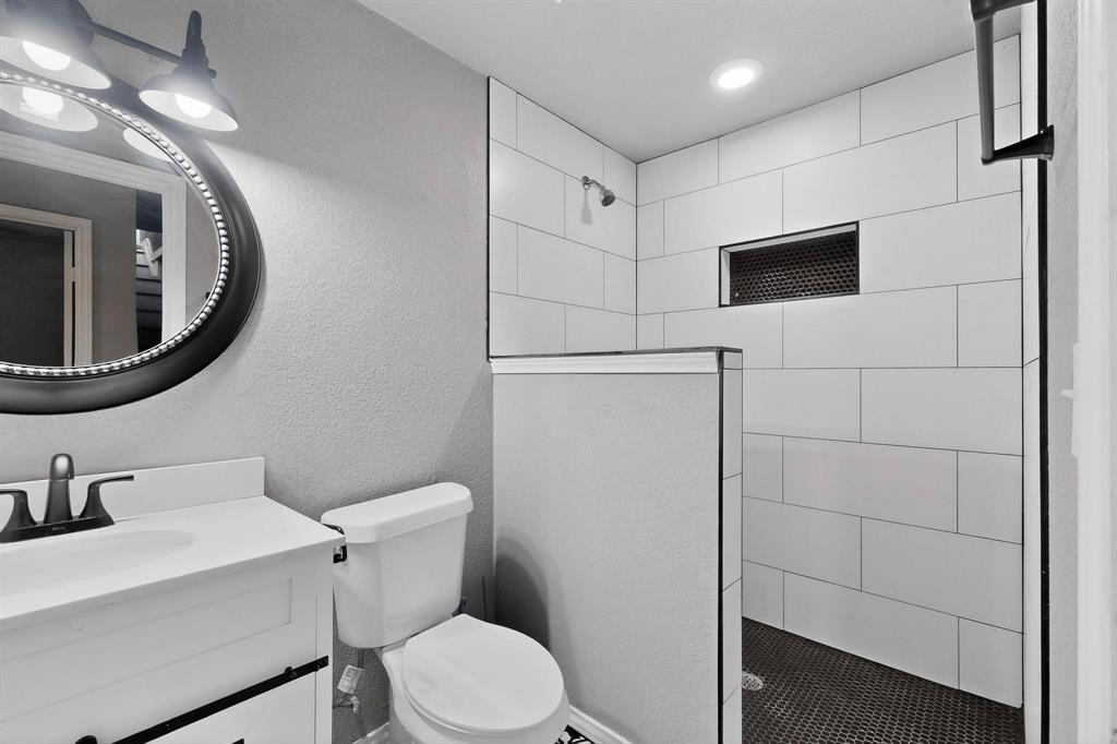 400 South Oak Street Ranger, TX 76470 - Photo 13 of 38 a white toilet sitting next to a bathroom sink