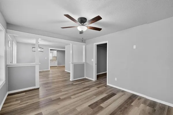 a view of an empty room and wooden floor
