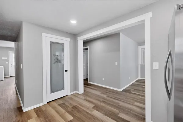 a view of a hallway with wooden floor