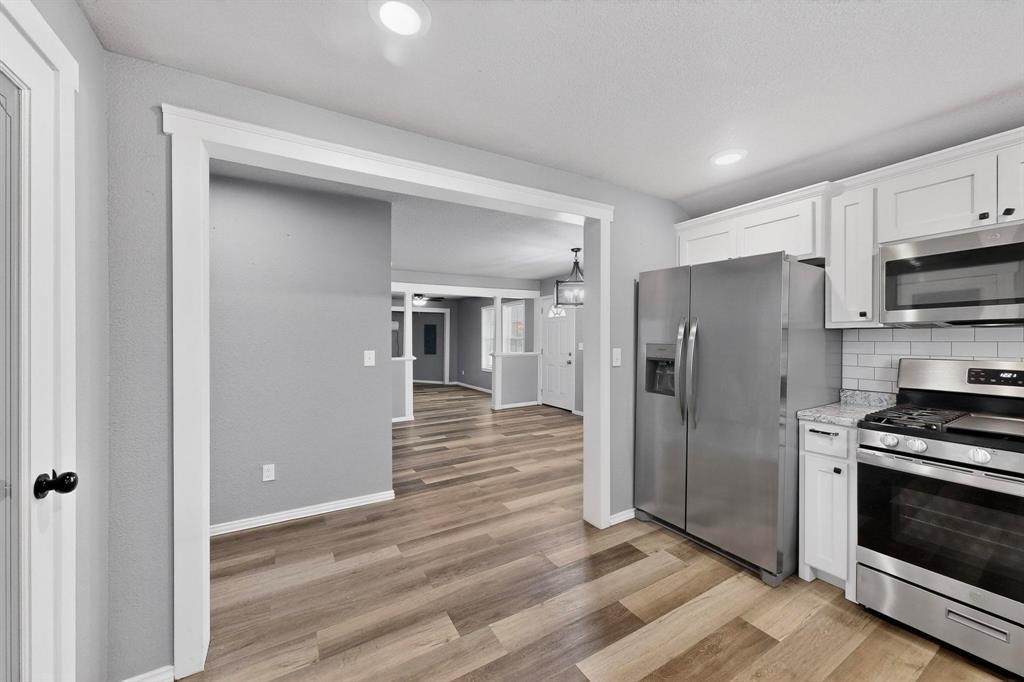 400 South Oak Street Ranger, TX 76470 - Photo 19 of 38 a kitchen with stainless steel appliances a refrigerator and a stove top oven