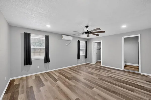 a view of a livingroom with a ceiling fan and window
