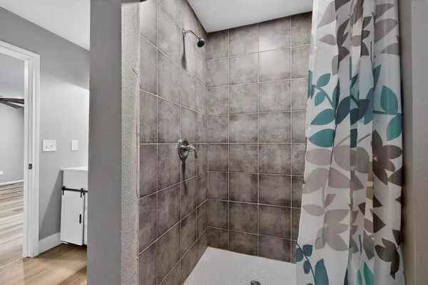 a bathroom with a shower and a sink