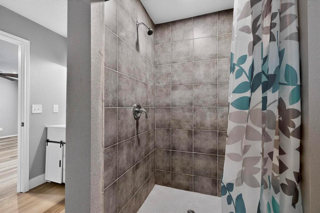 400 South Oak Street Ranger, TX 76470 - Photo 26 of 38 a bathroom with a shower and a sink