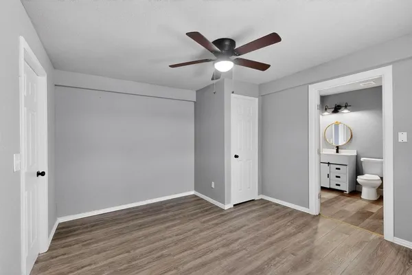 a view of a livingroom with wooden floor and a ceiling fan