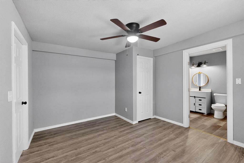 400 South Oak Street Ranger, TX 76470 - Photo 30 of 38 a view of a livingroom with wooden floor and a ceiling fan
