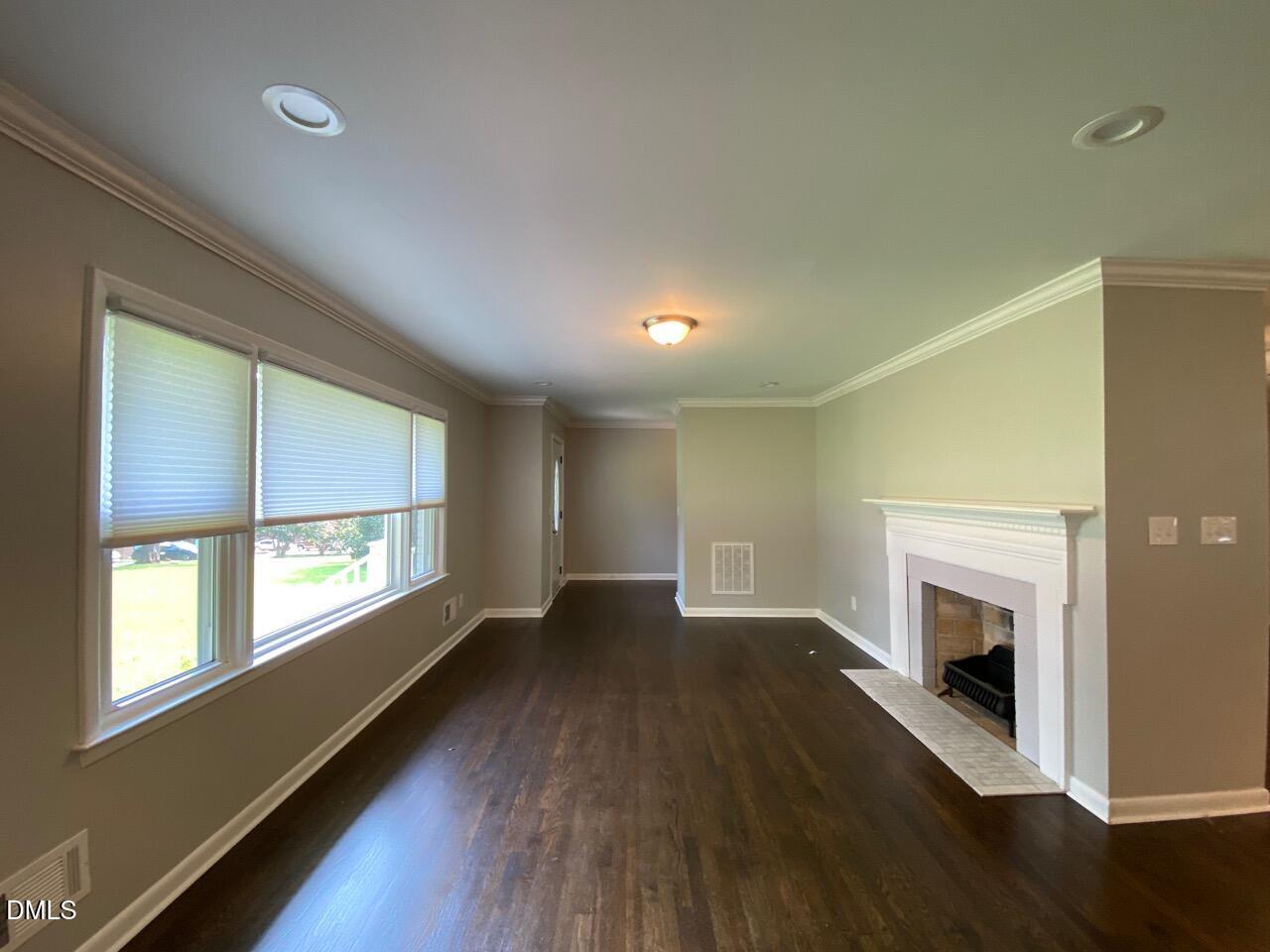 2910 Haven Road Raleigh, NC 27610 - Photo 11 of 26 a view of an empty room with wooden floor and a window