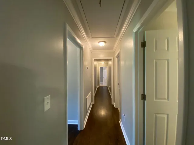a view of hallway with wooden floor