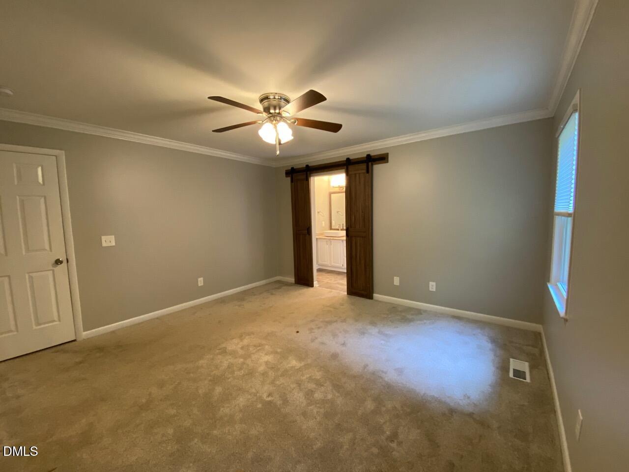 2910 Haven Road Raleigh, NC 27610 - Photo 19 of 26 an empty room with a ceiling fan and a window