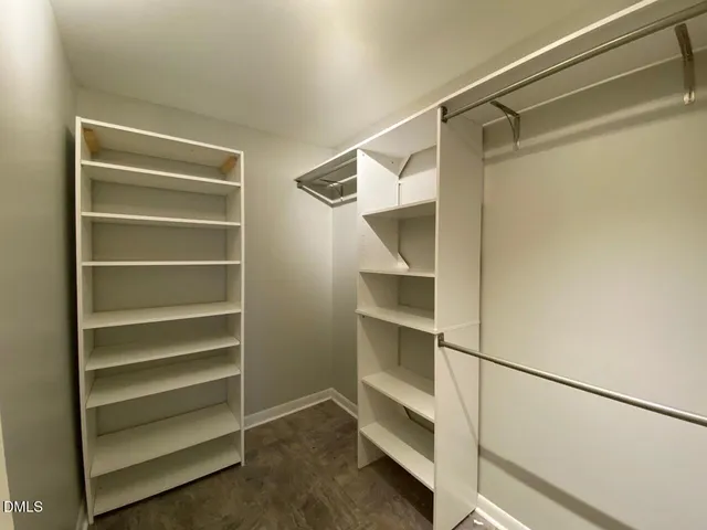 a view of walk in closet with empty racks