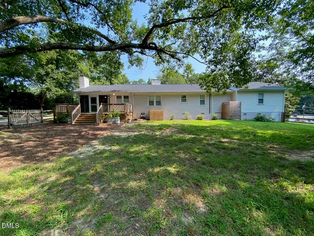 a house view with a sitting space and garden
