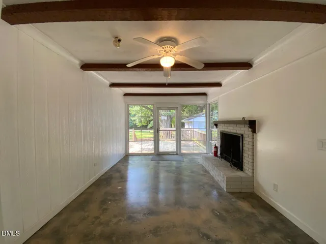 a view of empty room with a fireplace